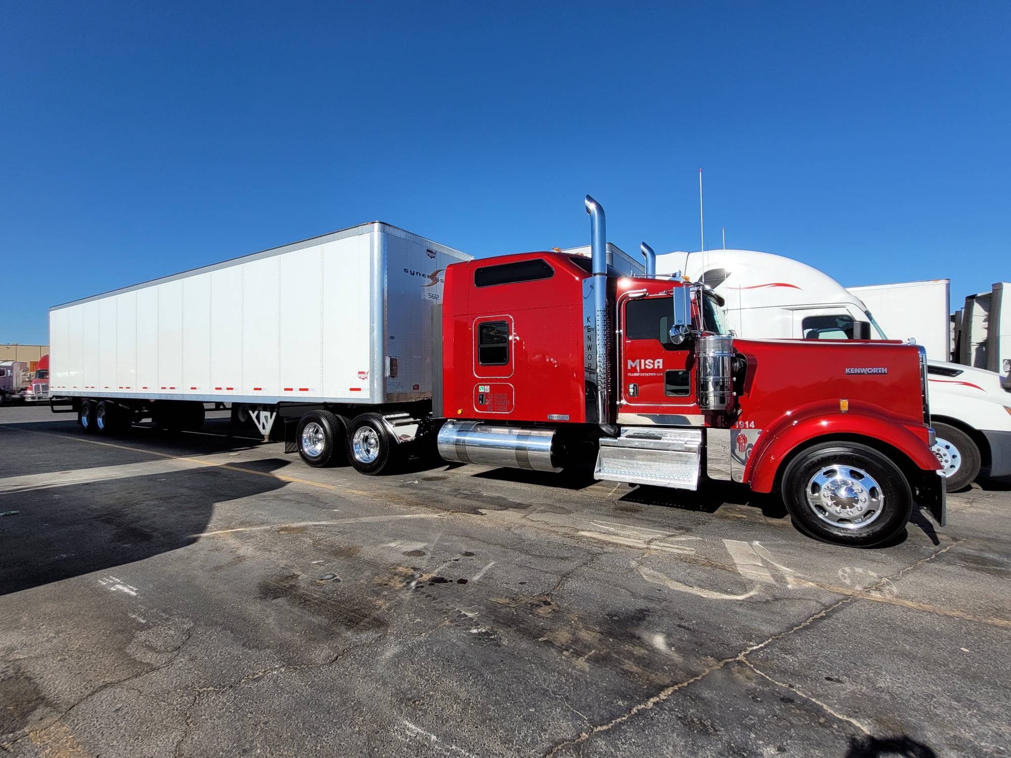 Misa Transportation red Kenworth tractor with white dry van trailer